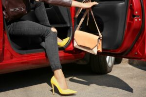 woman in car wearing high-heeled shoes