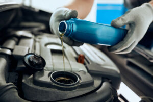 pouring engine oil into engine
