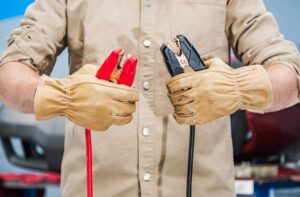 mechanic holding jumper cables